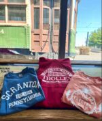 From left to right: Blue "Scranton, Pennsylvania" short sleeve tee shirt, Red "Electric City Trolley" hooded sweatshirt, Orange "Scranton The Electric City" short sleeve tee shirt